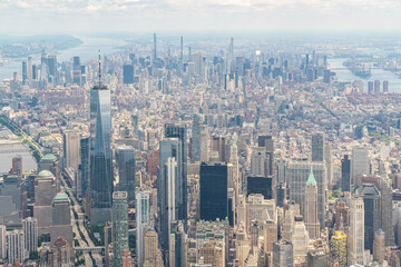 Fototapeta na wymiar Aerial panoramic city view of Upper Manhattan district with the top of the World Trade Center, New York, USA. Bird's eye view from helicopter of metropolis cityscape. A vibrant business neighborhood