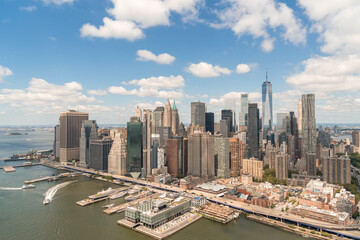Fototapeta na wymiar Aerial panoramic city view on Lower Manhattan district and financial Downtown, New York City, USA. Bird's eye view from helicopter. A vibrant business neighborhood. Hudson River and East River.