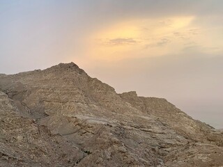 Sandstorm and sunset over Oman. Mountains next to the Emirates border
