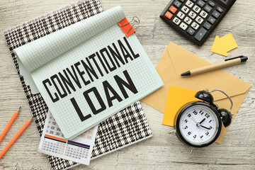 Conventional Loan open notepad on colorful notepad. calculator. a table clock