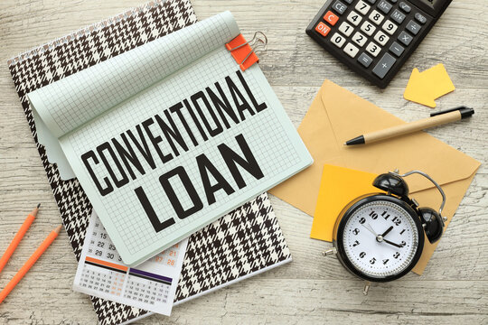 Conventional Loan open notepad on colorful notepad. calculator. a table clock