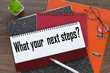 What is your next step. diary with text on orange folder - obrazy, fototapety, plakaty