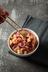 fish ceviche with onions and pepper. traditional peruvian food with tigra milk
