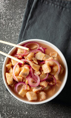 fish ceviche with onions and pepper. traditional peruvian food with tigra milk