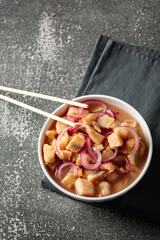 fish ceviche with onions and pepper. traditional peruvian food with tigra milk