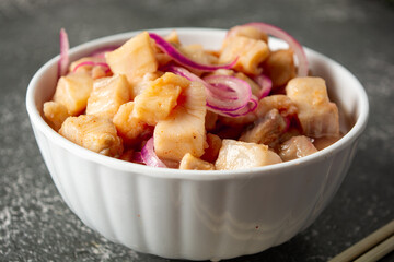 fish ceviche with onions and pepper. traditional peruvian food with tigra milk
