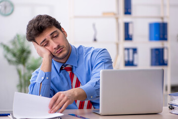 Young male employee working in the office