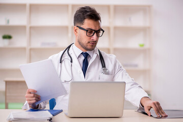 Young male doctor working at the hospital