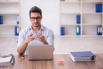 Young male employee in e-commerce concept