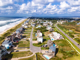 Fototapeta na wymiar town on the Atlantic Coast in North Carolina. Sandy beach, a line of low-rise houses and hotels along the coast. View from a drone.