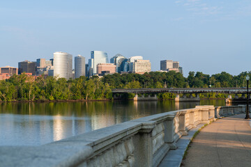 Panoramic view from Washington towards Arlington financial downtown city skyline at sunrise over the Potomac River. Virginia, USA. Business building facades as a concept of prosperous career.