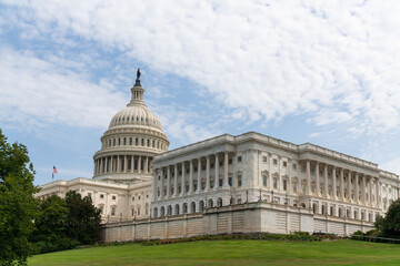 Fototapeta na wymiar Traditional neoclassical architecture of the Capitol dome building, Washington DC, USA. Home of Congress and Capitol Hill. The concept of legislative branch, American political system. Blue cloudy sky