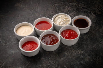 Assortment of sauces on the dark table