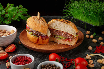 Burger with meat patty cut in halves, pickles, onions and lettuce