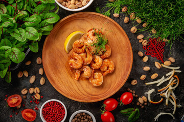 Hot appetizers. Fried shrimp in a plate with micro greens and lemon.