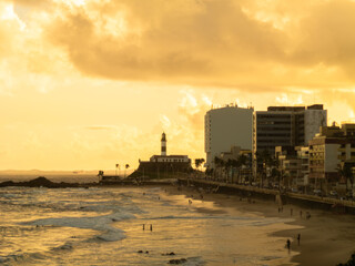 Fototapeta premium Sunset at Barra beach in Salvador Bahia with Barra Lighthouse in the background