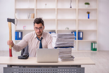 Young male employee unhappy with excessive work in the office