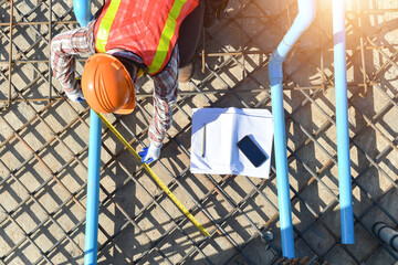 Overhead view of a building contractor checking foundations of a building, Thailand