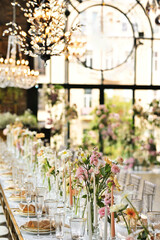 Fototapeta na wymiar beautiful elegant decor of flowers and elegant serving on the wedding table. Modern wedding decoration