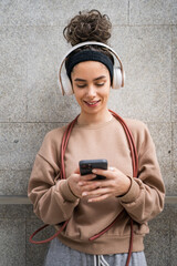 Fototapeta premium One young sporty woman with headphones use mobile phone app for music