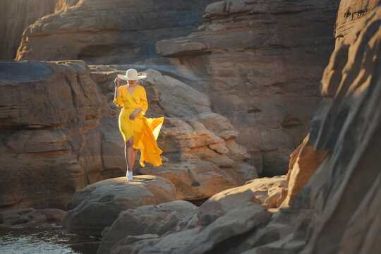 Woman standing  on rocks by Mekong River, Sam Pan Bok, Ubon Ratchathani, Thailand