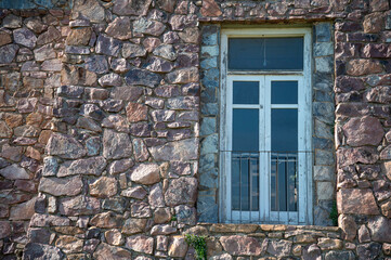 old window with stone wall, stone wall, limestone, rough stone wall background and wallpaper