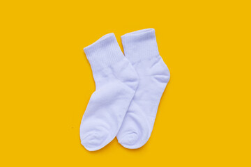 White socks on yellow background.
