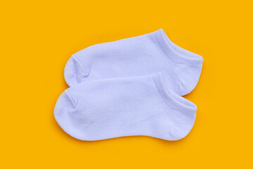 White socks on yellow background.