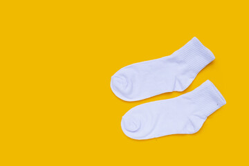 White socks on yellow background.