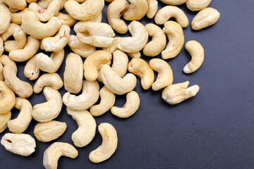 Cashew nuts on dark background.