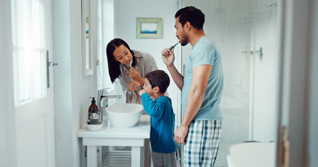 Parents, child and brushing teeth in family home bathroom while learning or teaching dental hygiene. A woman, man and kid with toothbrush and toothpaste for health, cleaning mouth and wellness - obrazy, fototapety, plakaty