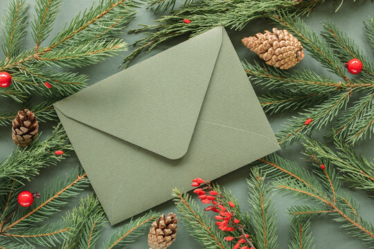 Overhead view of an envelope on fir branches, pinecones and berries