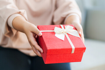 Woman preparing christmas or birth day gift at home.