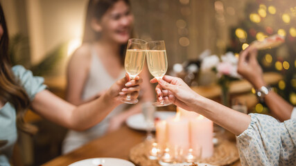 Closeup hands with glasses of champagne wine clink in christmas celebrate party festive.