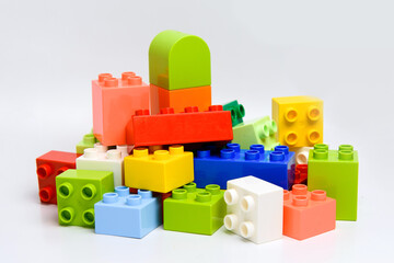 Parts of multicolored children's preschool toy constructor block heap.