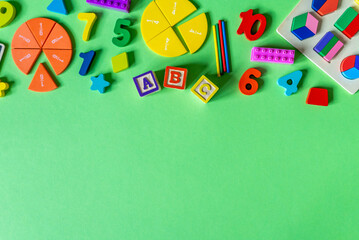 Colorful math fractions, numbers, letters on green background. Interesting, fun math for kids. Education, back to school concept	