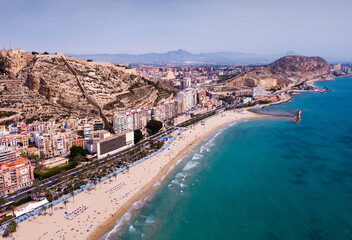 View of Alicante embankment and Mount Benacantil with medieval fortified castle on Mediterranean coast, Spain