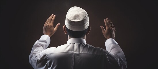 Fototapeta na wymiar Rear view of Muslim man praying to god