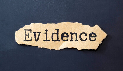 the word Evidence appearing behind torn white paper, gray background.