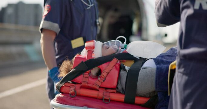 Paramedic, patient and oxygen for accident, stretcher or injury to lungs with help in street. First responder, healthcare expert and emergency on road for ems job, breathing and ambulance transport