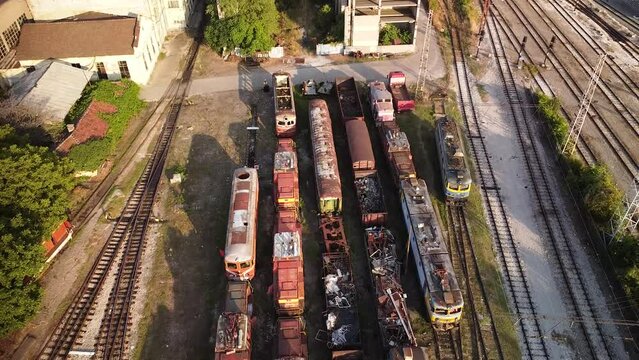 High angle 4k aerial drone footage of Train tracks, locomotives and wagons at Sofia central station railway depot and train yard. Rail infrastructure seen from above. 
