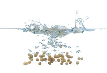 Yellow Beans falls into water and creates air bubbles on surface. Yellow beans drop hit smash to boil water and deep to bubble. White background isolated freeze motion