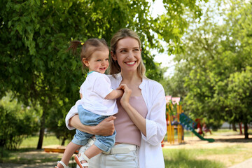 Fototapeta premium Happy mother with her daughter spending time together in park