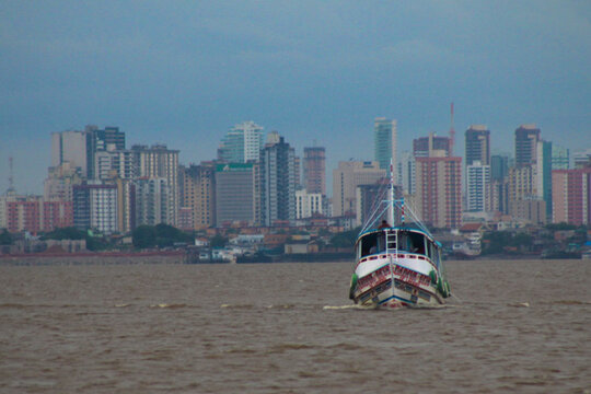 Amazon river boat at guam&aacute; river. Leaving concrete jungle