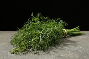 Bunch of fresh dill on grey table, closeup