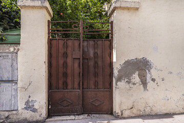 Deteriorated metal portal on the wall of a single-family home