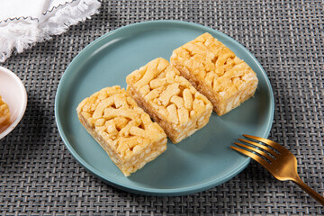 Chinese traditional dessert caramel treats or sachima on table.