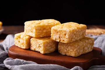 Chinese traditional dessert caramel treats or sachima on table.