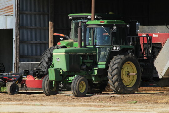 John Deere Farm Tractors Parked In A Farm Shed  Outdoors.