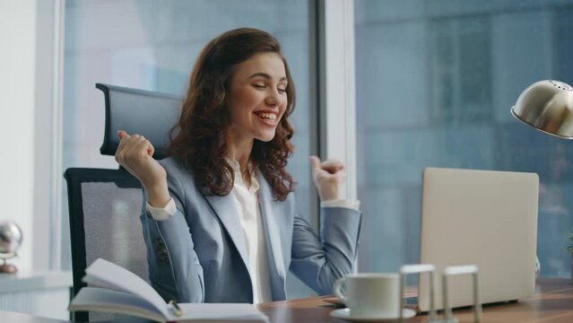 Woman winner looking laptop feeling happiness in office close up. Excited girl